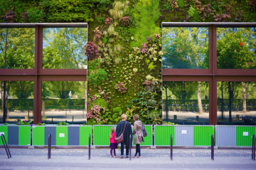 Visitors admire the green wall and sustainable architecture at the Musee du Quai Branly, Paris.