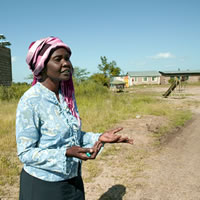 Kenyan woman speaking on side of road
