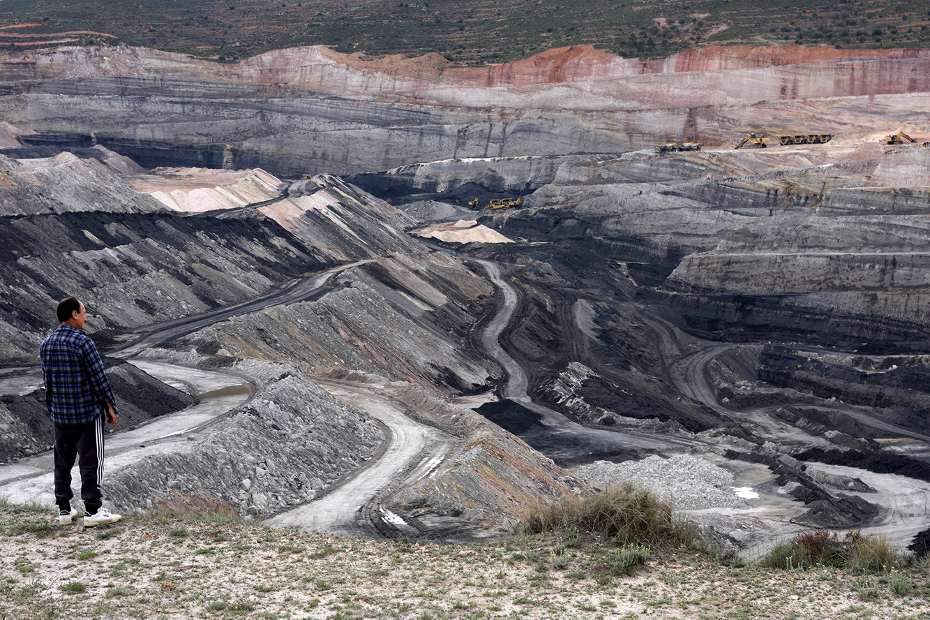The incredible scale of a coal mine in Estercuel, Spain, emphasised by an onlooker and the tiny (but in reality enormous) machinery in the background.