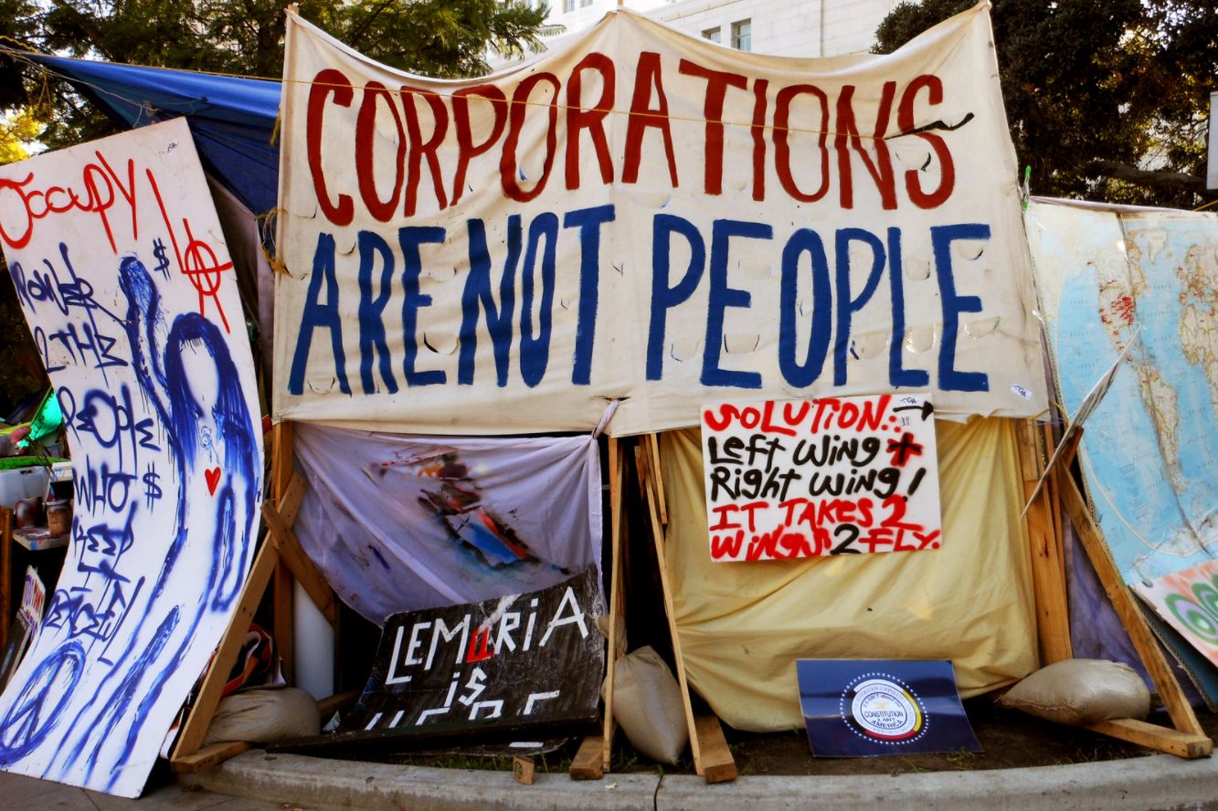 protest sign saying 'corporations are not people'