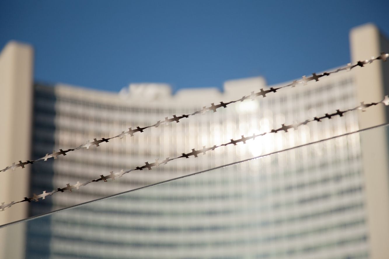 Large building with barbed wire in front of it